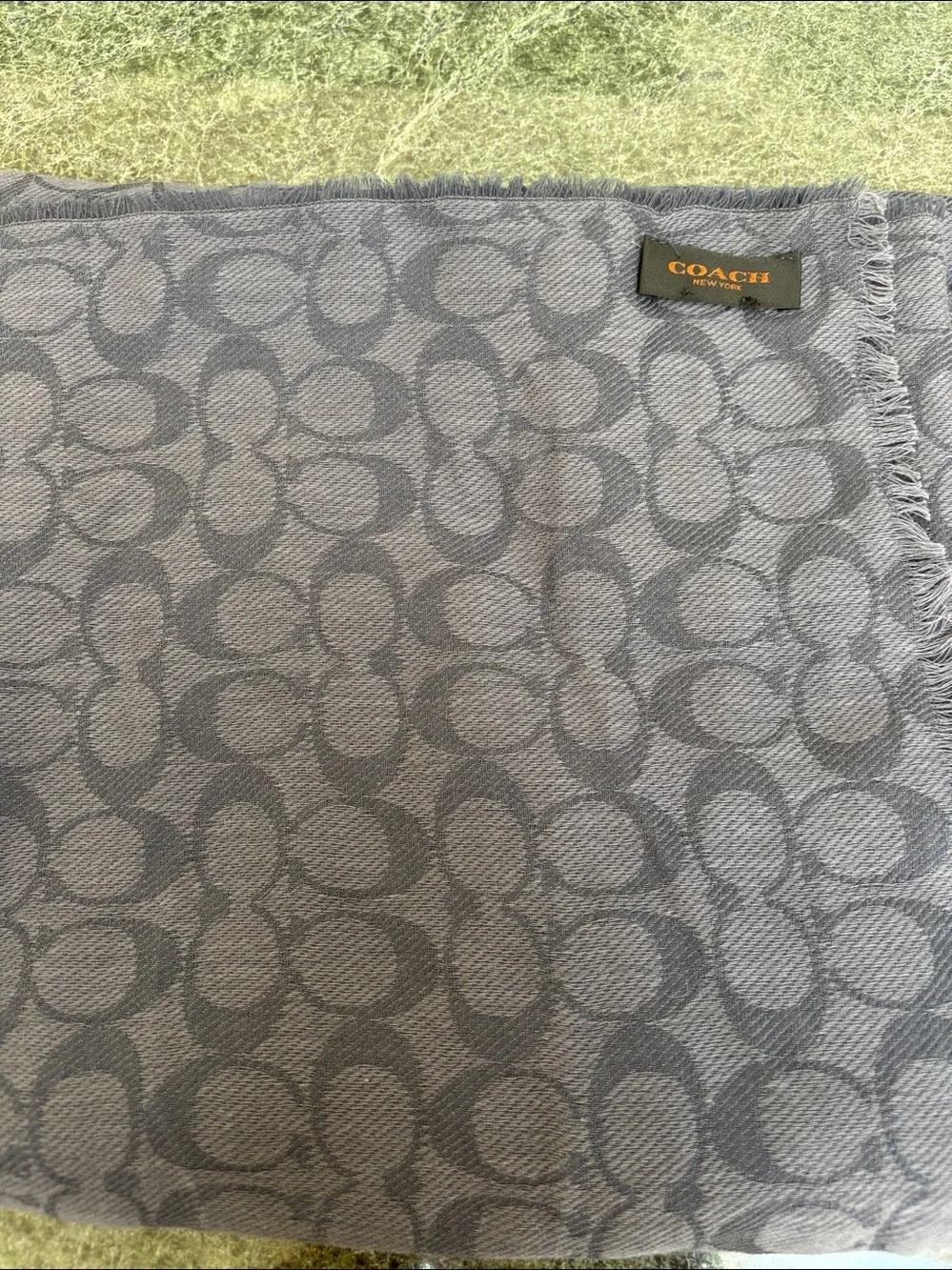 Coach Signature Wrap  made from a wool and silk blend with a tonal jacquard logo